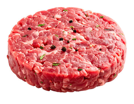 Hamburger patty made of raw ground beef seasoned with black pepper and fresh green herbs for delicious meal preparation