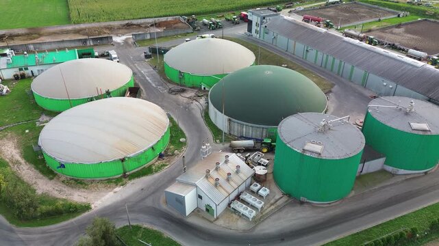 Drone shot of circular biogas digester tanks in eco friendly farm
