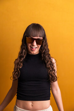 Young woman wearing stylish sunglasses smiling confidently