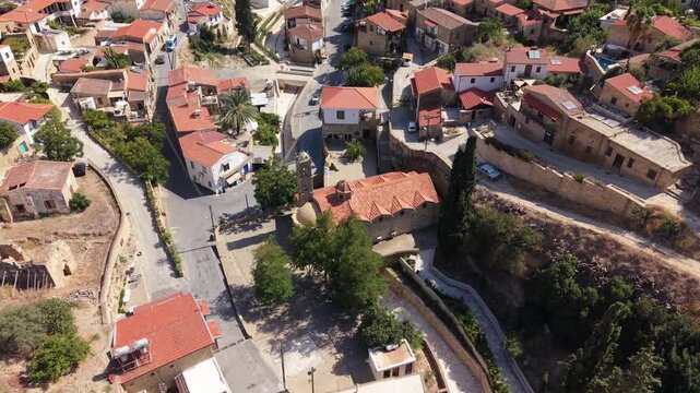 Aerial view of Tochni village in Cyprus showing the Holy Church of Saints Constantine and Helen, traditional stone houses, red tile roofs and narrow village streets