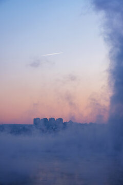 Misty morning blankets a frozen Angara riverbank