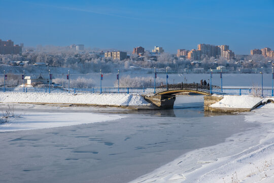 Misty morning blankets a frozen Angara riverbank