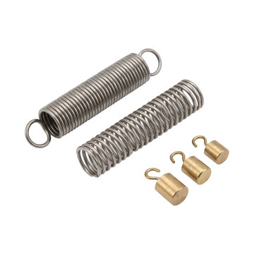 Industrial steel tension springs and brass calibration weights arranged neatly in isolation on transparent background