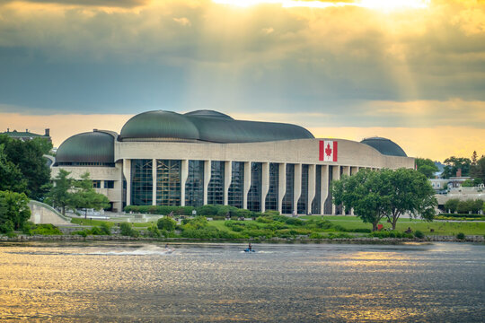 Ottawa, ON, Canada - Sept 14, 2026: Canadian Museum of History building seen across Ottawa River under dramatics sun rays at sunset.
