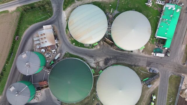 Drone shot of circular biogas digester tanks in eco friendly farm