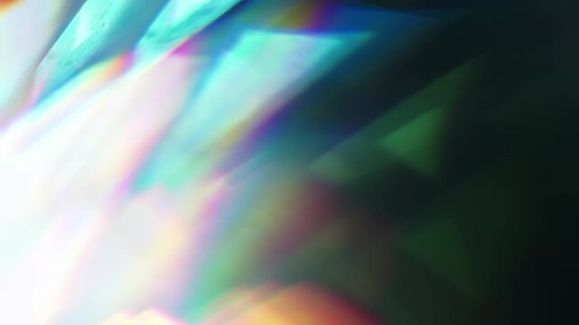 Light reflect burst illuminating the brilliance of a reflective prism. Radiant lighting creating a visual effect of light refraction in a rainbow colors and a dreamy rays of lights background. Loop