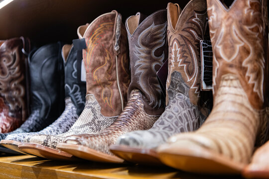 Boot male fashion shop. Shopping cowboy boots. Stylish western shoes boutique. Choosing western shoes. Variety of fashion cowboy male boots. Fashionable footwear clothes. Fashion footwear store