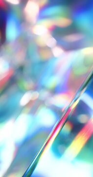 Light reflecting glass in brilliant saturated colors. Radiant lighting through a prism cube creating a visual of a colorful rainbow effect of light refraction. Spinning geometric abstract background.