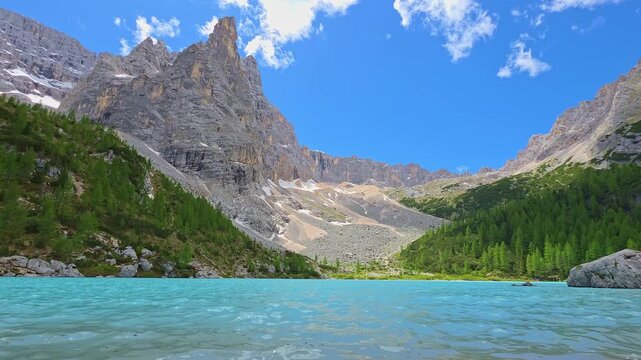 Turquoise Lake Sorapis surrounded by dramatic rocky peaks in the Italian Dolomites