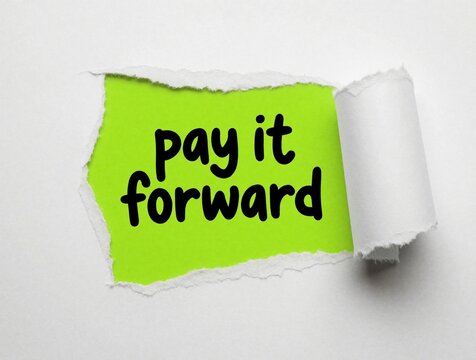 Text pay it forward appears on bright green paper through torn white overlay. Message promotes kindness and community support, ideal for motivational concepts and positive vibes.