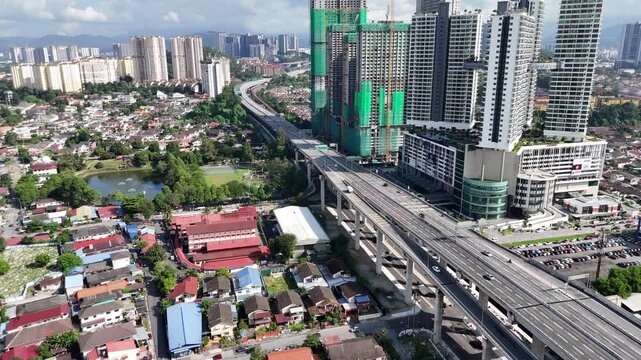 Aerial view of urban traffic moving along a multi-level highway flyover and road junction in Kuala Lumpur Malaysia