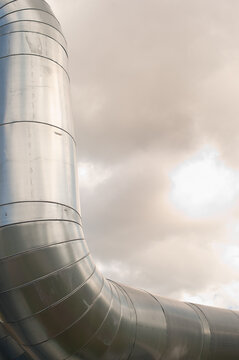 close-up of a pipeline against a gray sky