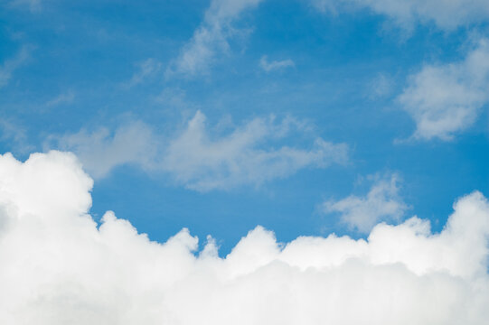 The photo shows a blue sky and clouds