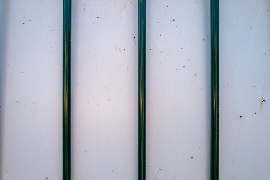 Four vertical green lines stand out on a light background