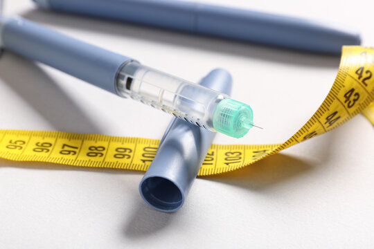 Weight loss medication and obesity treatment, insulin pen with measuring tape for diabetes management and health monitoring in a clinical setting