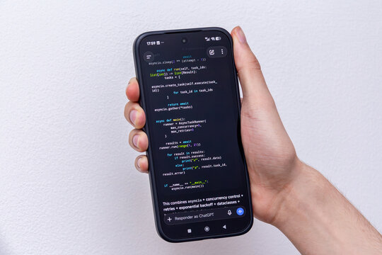 Hand holding Close-Up Smartphone Displaying Python Async Programming Code on a Clean White Background