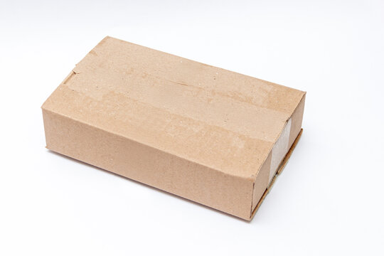 Plain kraft cardboard box isolated on a white background for shipping and packaging