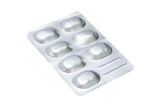 Seven white tablets sealed in a silver blister pack on a clean white background
