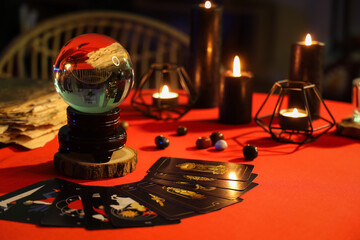 Fortune tellers magic attributes on red table in dark room, closeup © Pixel-Shot
