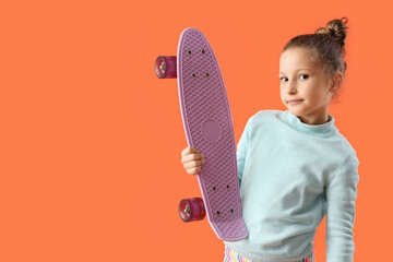 Adorable little girl with skateboard on orange background © Pixel-Shot