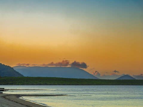 Sunset View Along Beach To Distant Hills