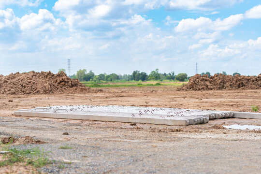 Concrete pillar piles placed on an earthwork development site for building structural foundation work.