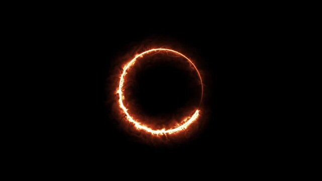 A glowing orange fire ring circle flame effect isolated on a black background for creative design projects
