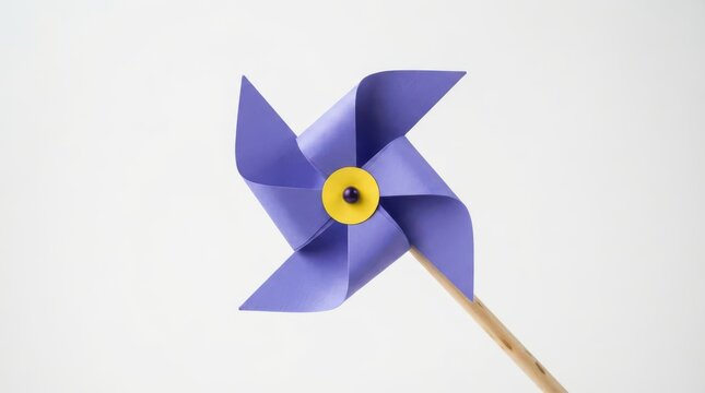 Purple paper pinwheel toy on a wooden stick isolated on white background