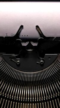 Vertical Macro Shot of Vintage Typewriter Typing the Words I Quit