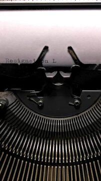 Vertical Macro Shot of Vintage Typewriter Typing the Words Resignation Letter