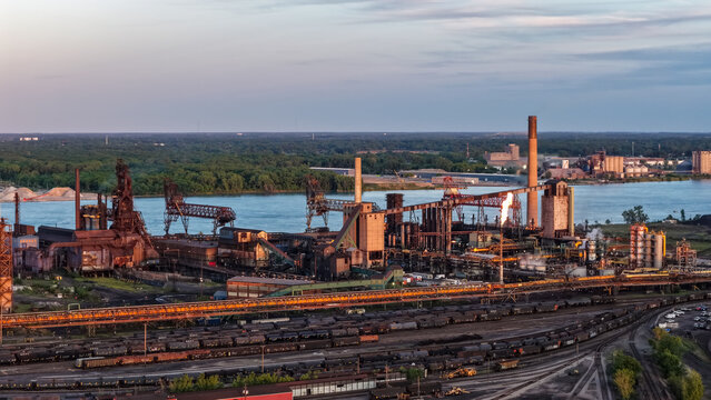 Industrial steel mill on Detroit River with freight trains