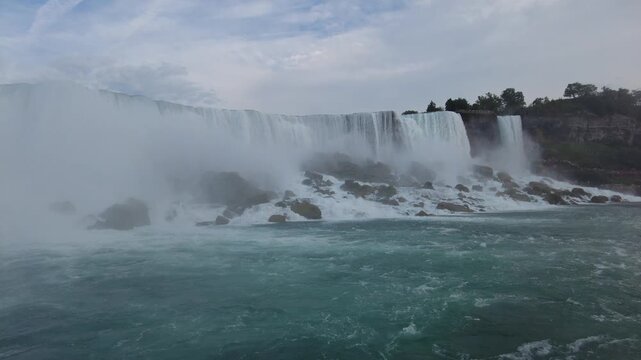 American Falls and Bridal Veil Falls cascading onto the rock talus at their base, seen from the Niagara River