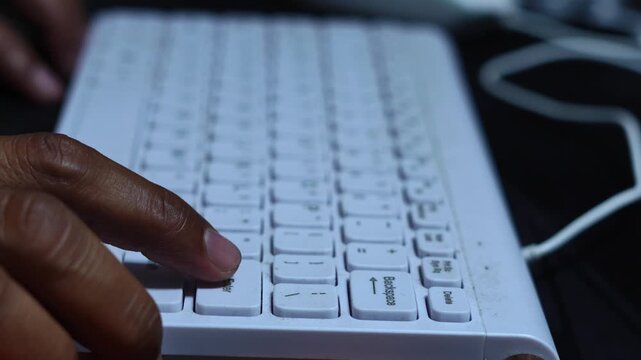 Person pressing the enter key on a computer keyboard