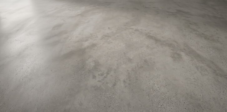 A smooth, polished gray concrete floor surface with subtle mottled textures, light reflections, and a soft gradient of shadows across the expansive, flat ground plane