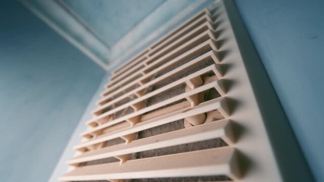 Dirty Air Vent Grille Close-Up: Dust-Covered Ventilation Cover with Wide Angle Lens | Camera Tilting Down Along HVAC Air Duct | Home Maintenance Needed