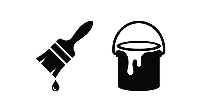 Black paint brush dripping with wet liquid paint positioned next to a metal bucket filled with thick color for home renovation and artistic wall projects