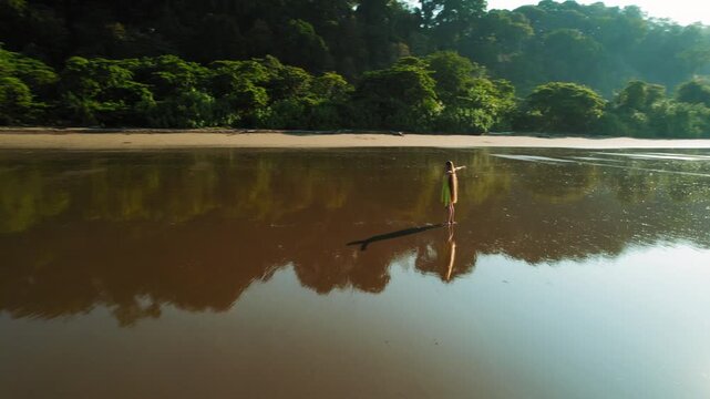 Woman enjoying life on reflective Playa Hermosa beach in tropical Costa Rica