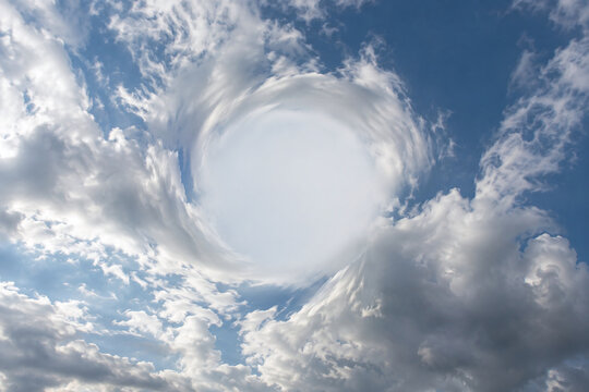 Surreal Cloud Vortex Warping Across Blue Sky