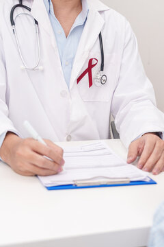 Doctor and patient having a medical consultation for burgundy ribbon concept of March Multiple Myeloma Cancer Awareness month, September Sickle Cell Anemia, Headache and Migraine week