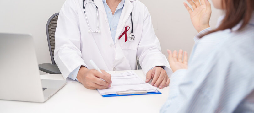 Doctor and patient having a medical consultation for burgundy ribbon concept of March Multiple Myeloma Cancer Awareness month, September Sickle Cell Anemia, Headache and Migraine week
