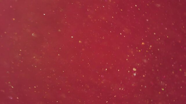 Bokeh leak twirl. Flare glimmer. Red orange whirl mixing flow. Bright shimmering light color particles spill abstract art background.