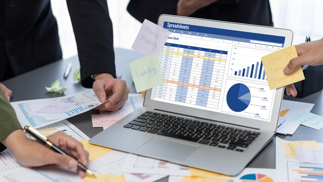 Analyst team use sticky note for creative and analytic brainstorm for business idea with BI data dashboard on laptop screen. Analysis financial data visualization tech for marketing strategy. Prodigy