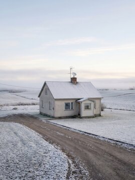 Rural Winter House With Satellite Dish and Antenna for Internet Connectivity