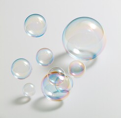Obraz premium Colorful soap bubbles floating against a white background