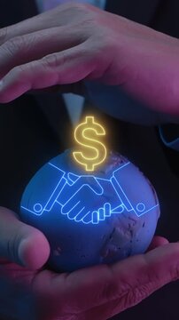 Close-up vertical shot of hands protecting world globe model with business handshake and dollar growth arrow. Global investment partnership revenue, international venture, and wealth idea concept.