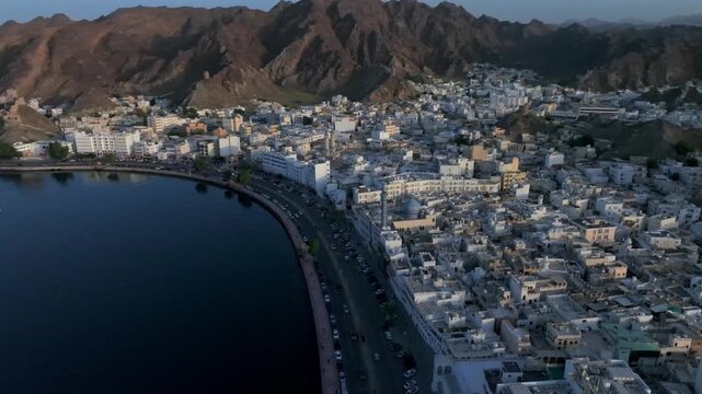 Aerial Evening View of Mutrah Corniche Muscat Oman with Hajar Mountains