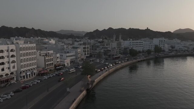 Aerial Evening View of Mutrah Corniche Muscat Oman with Hajar Mountains