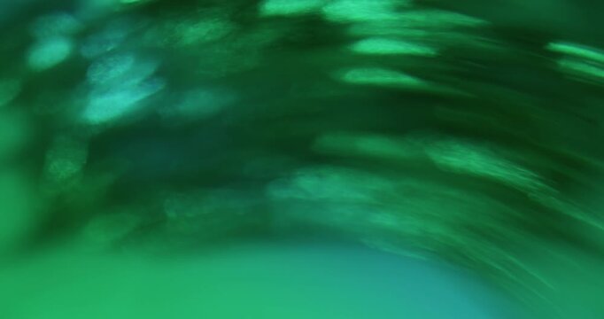 Bokeh green ray. Light art. Defocused blue color radiant visual glisten optical texture circle on abstract illuminated background.