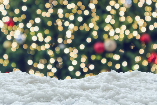 Empty white snow with blur Christmas tree with bokeh light background