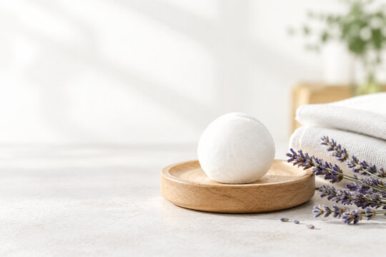Camphor ball on wooden coaster with cotton cloth and dried lavender